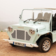 A photo of a Moke Californian EV on a cliff.